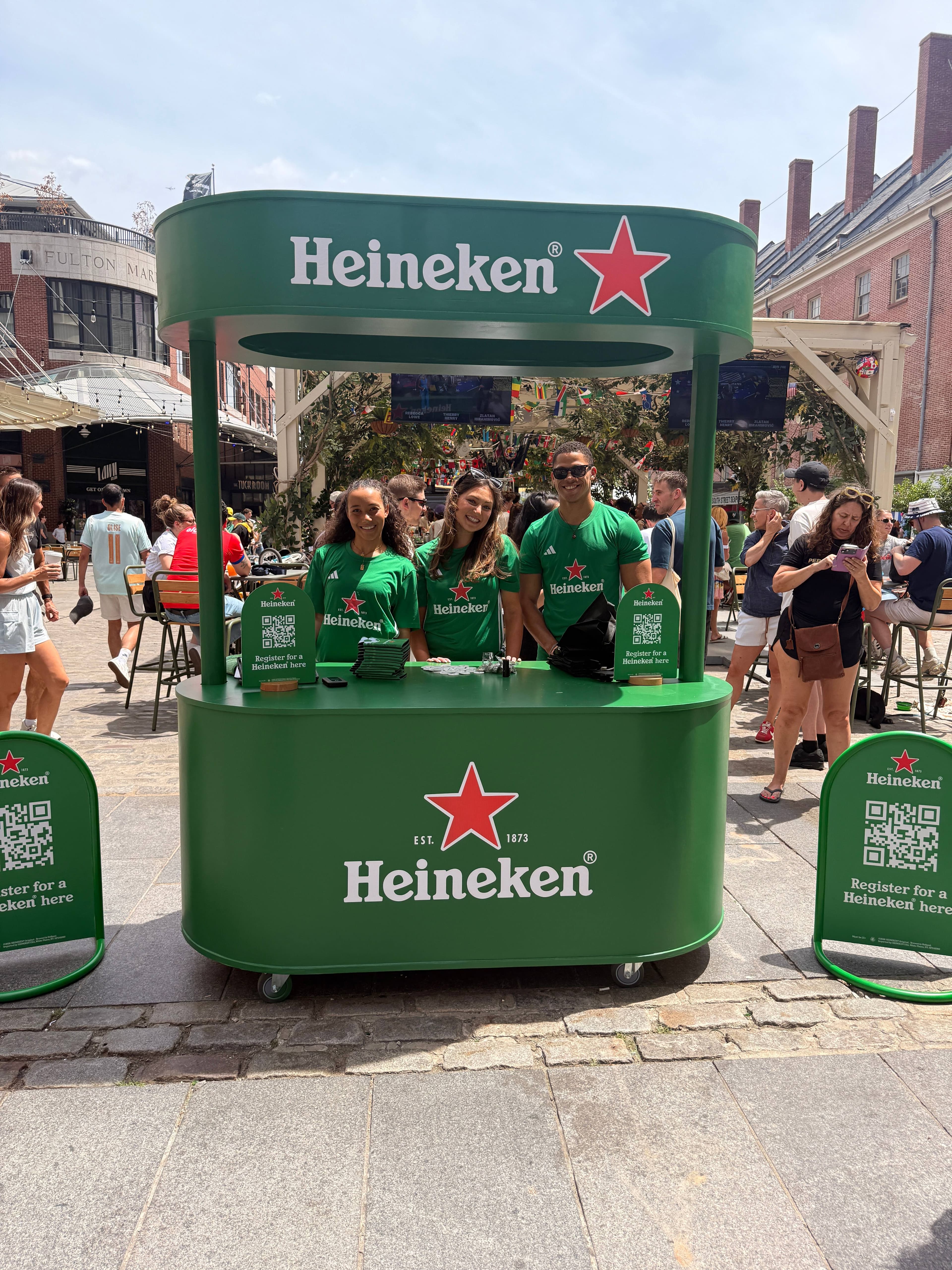Custom green Heineken branded mobile bar cart with brand ambassadors at South Street Seaport